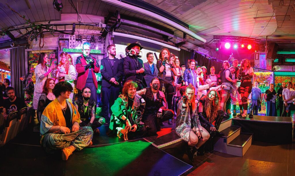 Group of around twenty people dressed in cyber punk costumes.