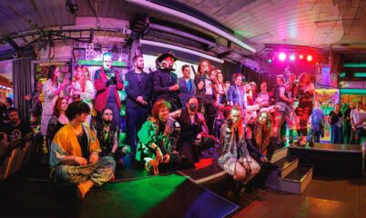 Group of around twenty people dressed in cyber punk costumes.